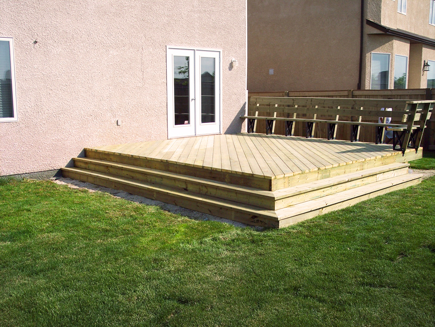 Wooden deck with steps and grass
