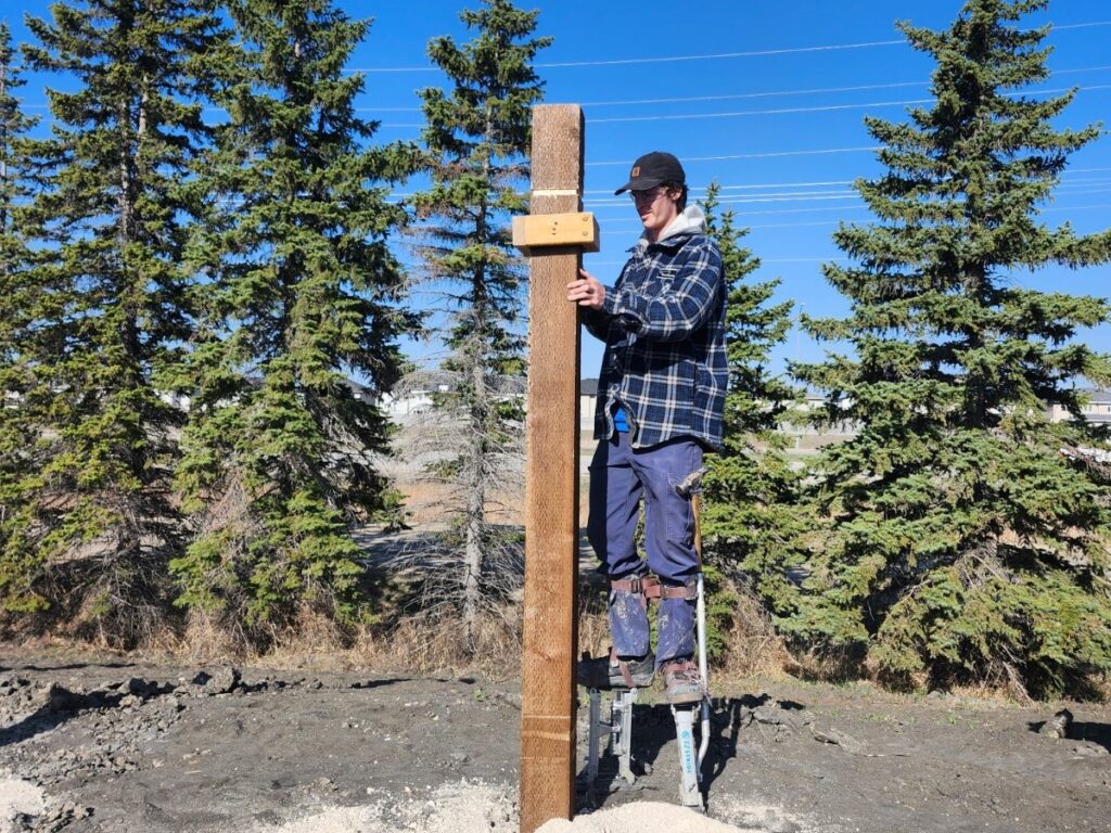 Person working on wooden post
